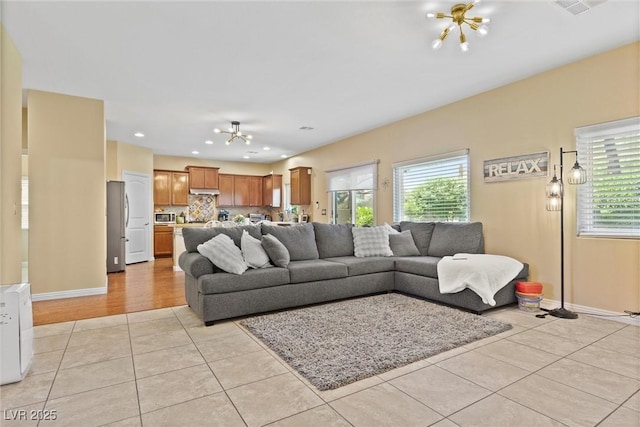 6049 Paddleboat St, North Las Vegas, NV 89031 - living room featuring light tile patterned flooring, healthy amount of natural light, a chandelier, and recessed lighting