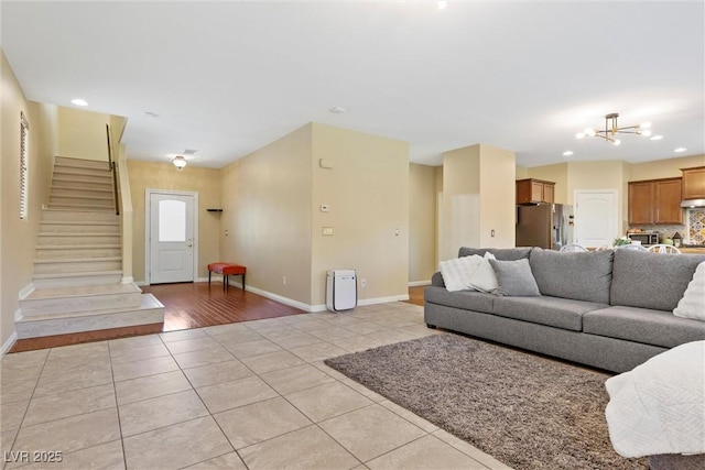 6049 Paddleboat St, North Las Vegas, NV 89031 - living area featuring light tile patterned floors, stairway, a chandelier, baseboards, and recessed lighting
