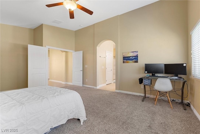 6049 Paddleboat St, North Las Vegas, NV 89031 - bedroom with arched walkways, a towering ceiling, carpet floors, baseboards, and multiple windows