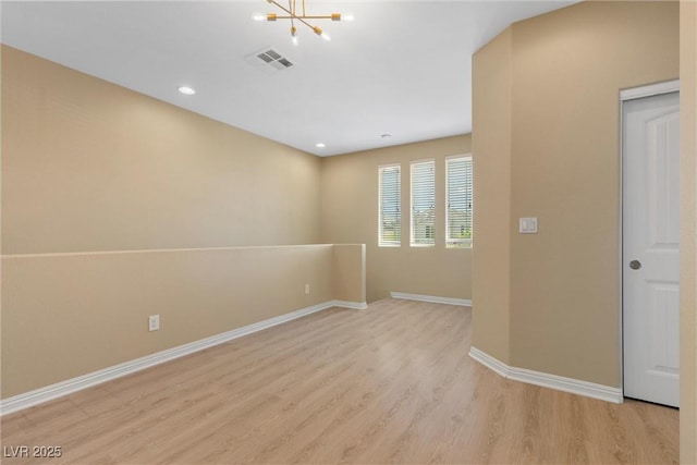 6049 Paddleboat St, North Las Vegas, NV 89031 - empty room with a chandelier, light wood-type flooring, baseboards, and recessed lighting