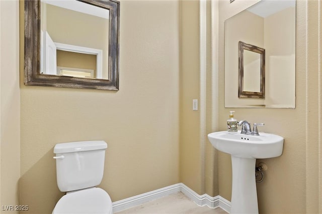 6049 Paddleboat St, North Las Vegas, NV 89031 - bathroom featuring toilet, baseboards, and a sink