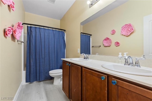 6049 Paddleboat St, North Las Vegas, NV 89031 - full bath with toilet, wood finished floors, double vanity, and shower / tub combo with curtain