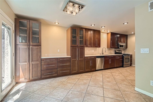 kitchen with stainless steel appliances, light countertops, plenty of natural light, and recessed lighting