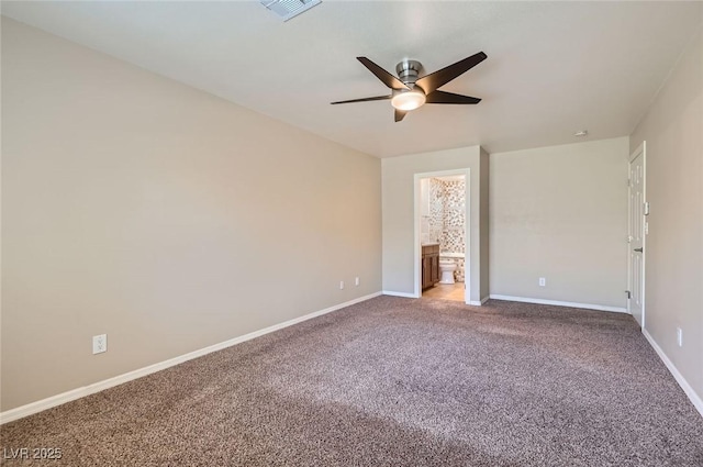 unfurnished bedroom featuring carpet flooring, baseboards, ensuite bathroom, and a ceiling fan