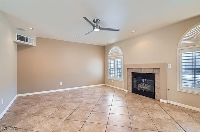 unfurnished living room featuring plenty of natural light, ceiling fan, light tile patterned floors, recessed lighting, and a fireplace
