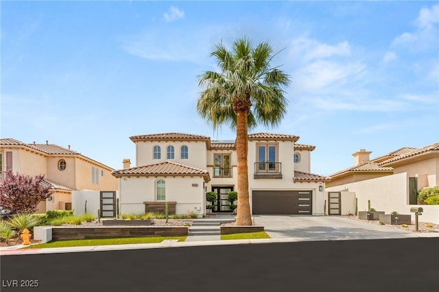11453 Glowing Sunset Ln, Las Vegas, NV 89135 - mediterranean / spanish home featuring stucco siding, an attached garage, driveway, and a tiled roof
