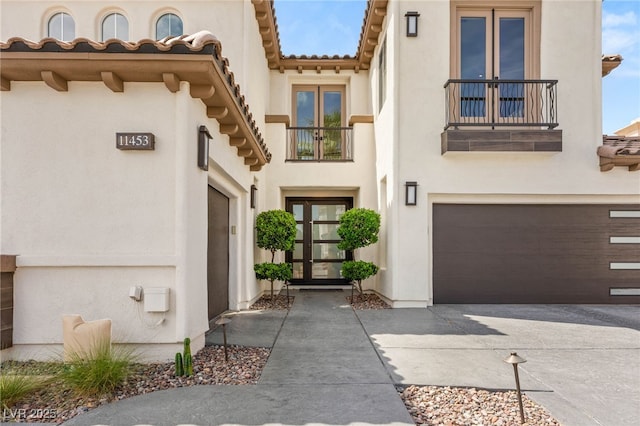 11453 Glowing Sunset Ln, Las Vegas, NV 89135 - entrance to property with a balcony, stucco siding, concrete driveway, a tile roof, and a garage