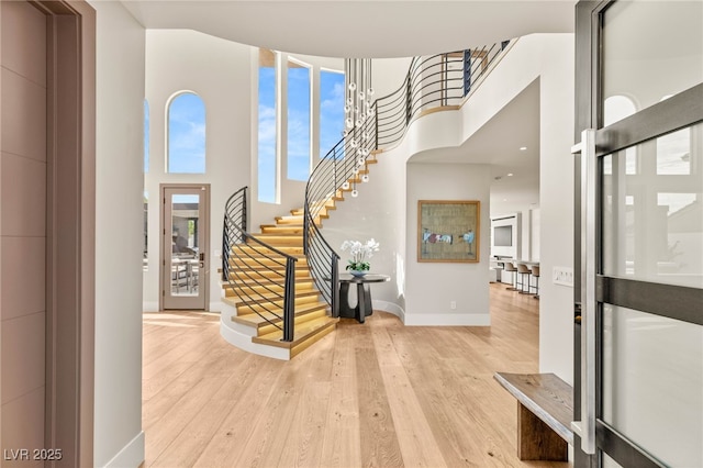 11453 Glowing Sunset Ln, Las Vegas, NV 89135 - entrance foyer with a towering ceiling, wood finished floors, stairway, and baseboards