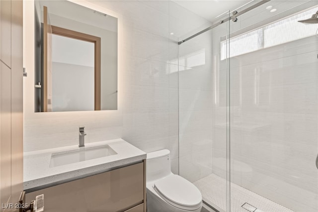 11453 Glowing Sunset Ln, Las Vegas, NV 89135 - bathroom featuring toilet, vanity, a stall shower, and tile walls