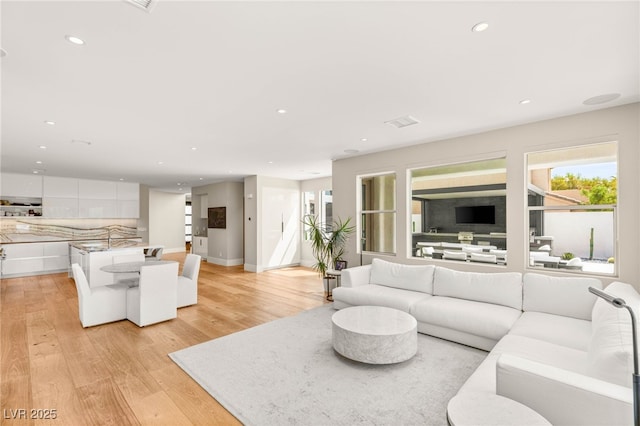 11453 Glowing Sunset Ln, Las Vegas, NV 89135 - living room with light wood-style flooring, recessed lighting, plenty of natural light, and baseboards
