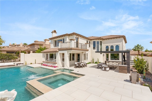 11453 Glowing Sunset Ln, Las Vegas, NV 89135 - back of property featuring a balcony, a patio, stucco siding, a pool with connected hot tub, and a tiled roof