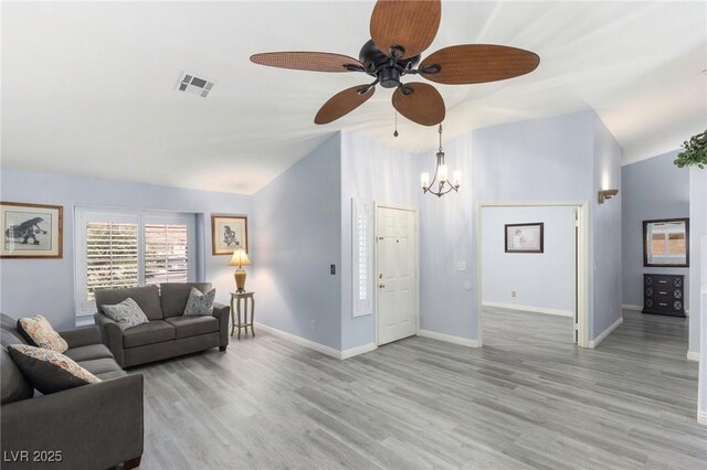 5441 Rose Hills St, Las Vegas, NV 89149 - living room featuring lofted ceiling, light wood-type flooring, ceiling fan, baseboards, and a chandelier