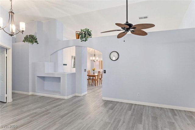 5441 Rose Hills St, Las Vegas, NV 89149 - unfurnished living room with a chandelier, wood finished floors, high vaulted ceiling, and a ceiling fan