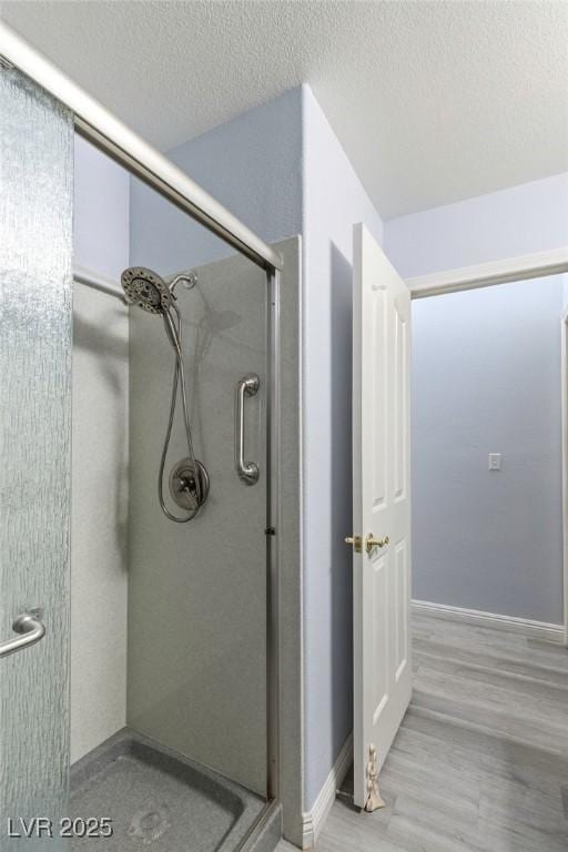 5441 Rose Hills St, Las Vegas, NV 89149 - bathroom with a shower stall, baseboards, and a textured ceiling