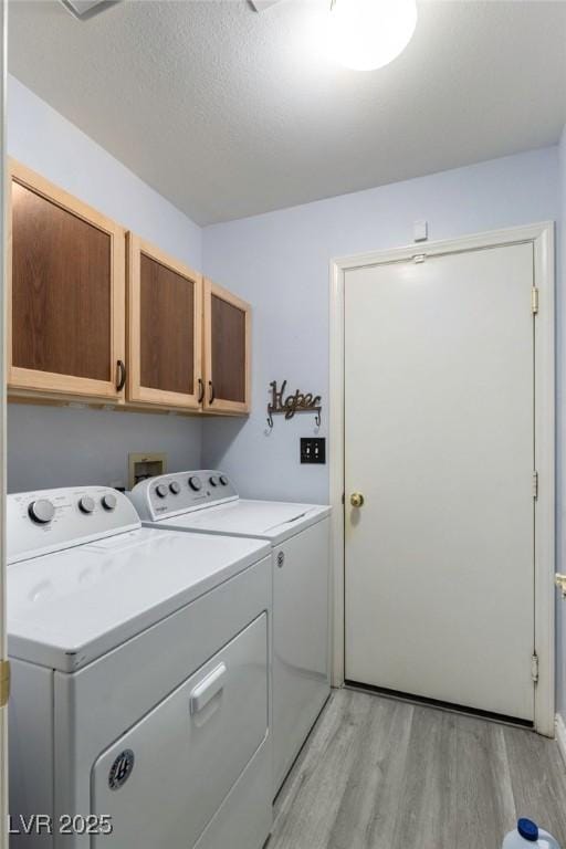 5441 Rose Hills St, Las Vegas, NV 89149 - laundry area with cabinet space, light wood finished floors, separate washer and dryer, and a textured ceiling