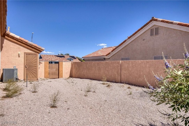 5441 Rose Hills St, Las Vegas, NV 89149 - view of yard featuring fence and central AC