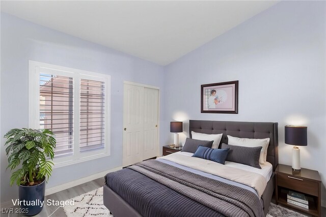 5441 Rose Hills St, Las Vegas, NV 89149 - bedroom featuring wood finished floors, lofted ceiling, and baseboards
