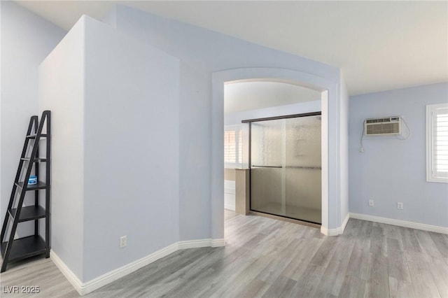 5441 Rose Hills St, Las Vegas, NV 89149 - empty room featuring wood finished floors, healthy amount of natural light, and a wall unit AC
