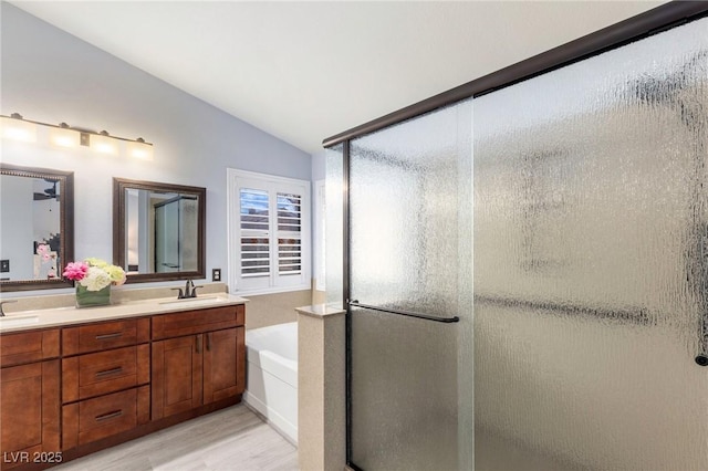 5441 Rose Hills St, Las Vegas, NV 89149 - full bath featuring lofted ceiling, wood finished floors, a stall shower, a garden tub, and double vanity