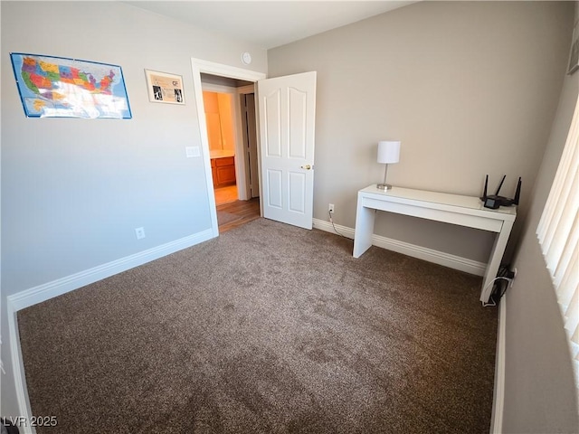 unfurnished bedroom with baseboards and carpet flooring
