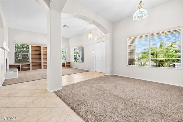 9282 W Viking Rd, Las Vegas, NV 89147 - carpeted foyer entrance featuring tile patterned flooring, arched walkways, and baseboards