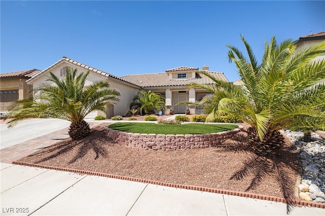 9282 W Viking Rd, Las Vegas, NV 89147 - mediterranean / spanish home with driveway, stucco siding, an attached garage, and a tiled roof
