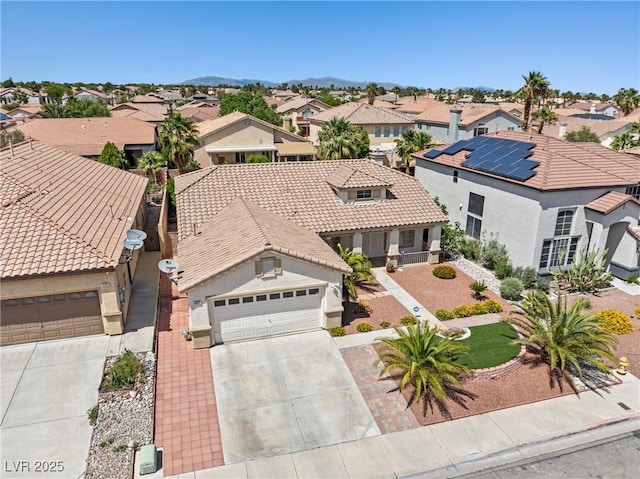 9282 W Viking Rd, Las Vegas, NV 89147 - view of front of home featuring a residential view, driveway, a tiled roof, and stucco siding