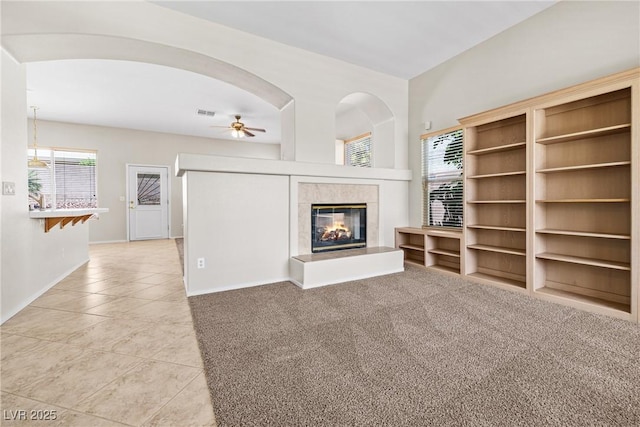 9282 W Viking Rd, Las Vegas, NV 89147 - unfurnished living room with light tile patterned floors, a tile fireplace, baseboards, and ceiling fan