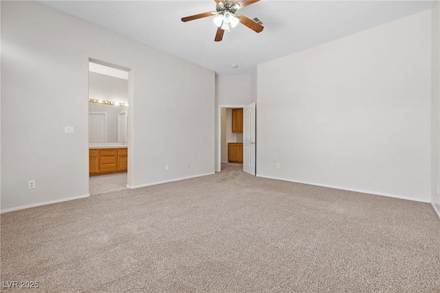 9282 W Viking Rd, Las Vegas, NV 89147 - unfurnished bedroom with light colored carpet, baseboards, ensuite bathroom, and ceiling fan