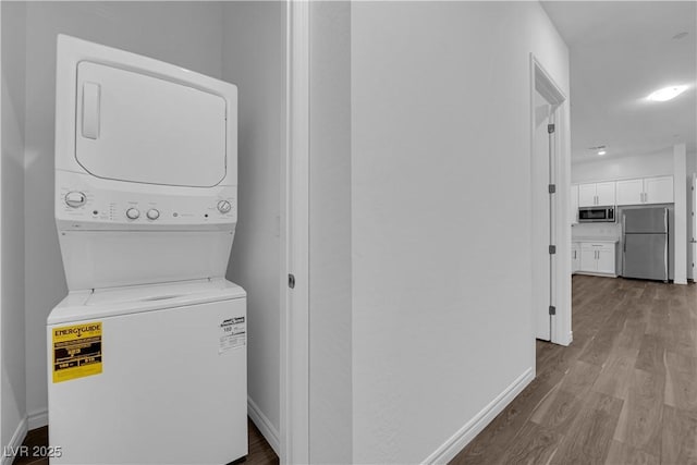 720 Webber Park St, Henderson, NV 89011 - laundry room with stacked washing machine and dryer, wood finished floors, and baseboards