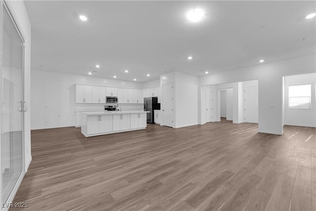 720 Webber Park St, Henderson, NV 89011 - unfurnished living room with light wood-type flooring, baseboards, and recessed lighting