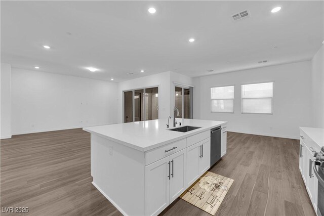 720 Webber Park St, Henderson, NV 89011 - kitchen with a sink, dishwashing machine, light wood-type flooring, a kitchen island with sink, and white cabinetry