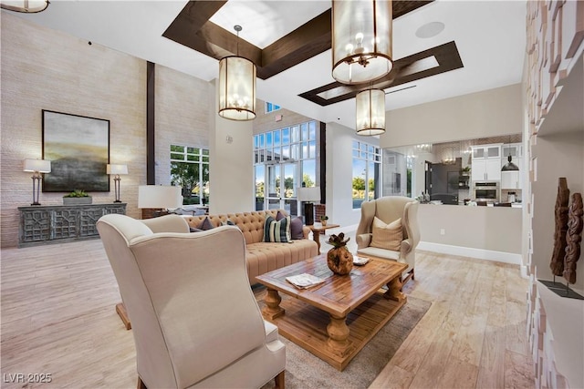 720 Webber Park St, Henderson, NV 89011 - living area with a chandelier, light wood finished floors, beamed ceiling, and baseboards