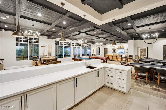 720 Webber Park St, Henderson, NV 89011 - kitchen featuring coffered ceiling, a chandelier, open floor plan, light countertops, and pendant lighting