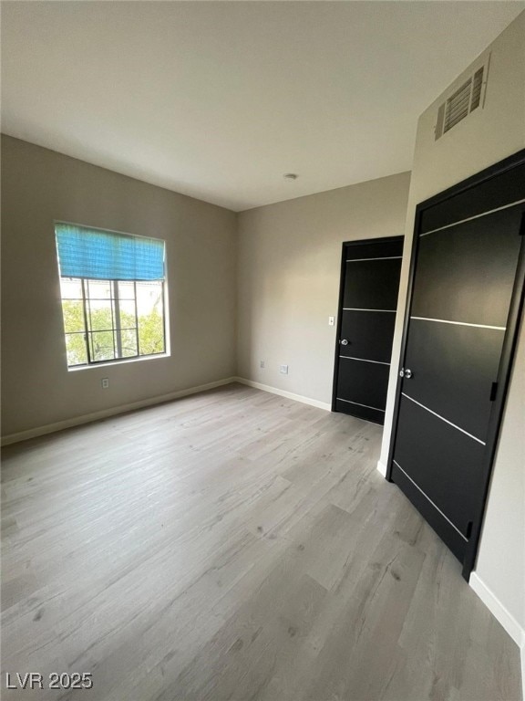 2151 Hussium Hills St Unit 207, Las Vegas, NV 89108 - unfurnished bedroom with light wood-style flooring and baseboards