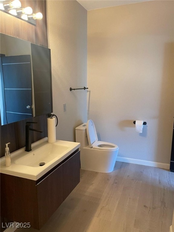 2151 Hussium Hills St Unit 207, Las Vegas, NV 89108 - half bath with toilet, wood finished floors, vanity, and baseboards