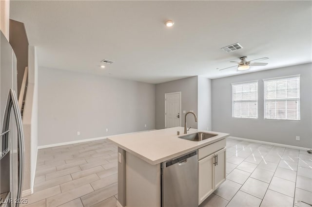 1201 Seaboard Ct, Henderson, NV 89002 - kitchen featuring stainless steel appliances, a sink, open floor plan, light countertops, and a ceiling fan