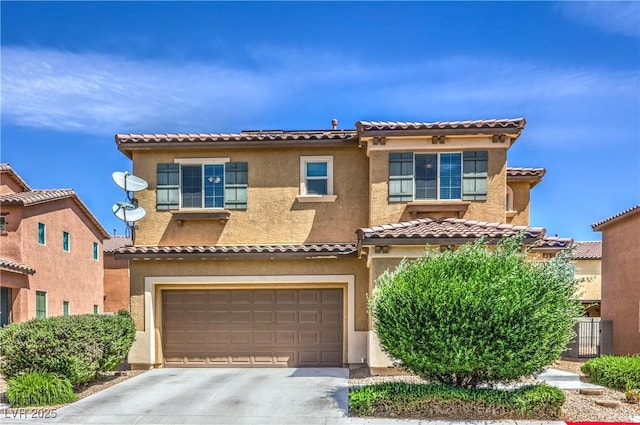 mediterranean / spanish-style house featuring an attached garage, concrete driveway, stucco siding, and a tile roof