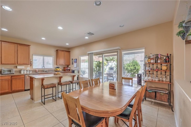 dining space featuring light tile patterned flooring and recessed lighting