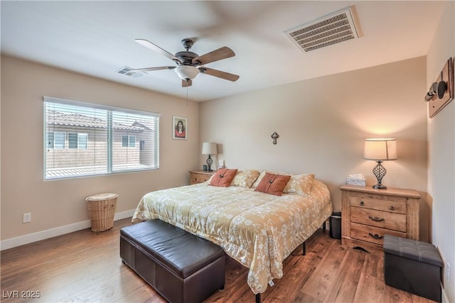 bedroom with wood finished floors, baseboards, and ceiling fan