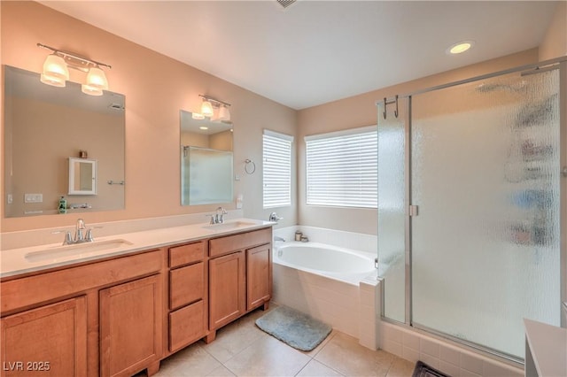 bathroom with tile patterned floors, a stall shower, a garden tub, and double vanity