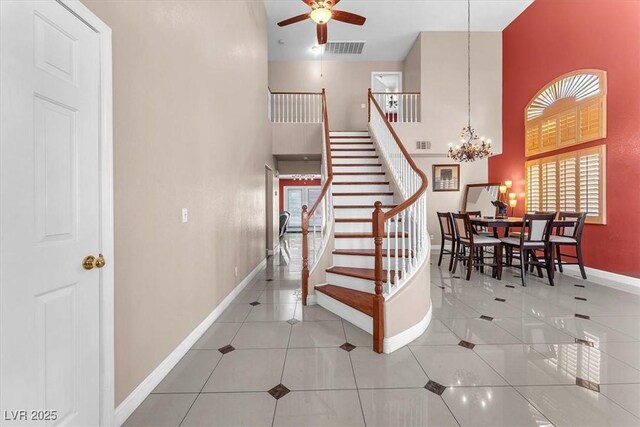 2104 Spanish Town Ave, North Las Vegas, NV 89031 - stairway with plenty of natural light, baseboards, a towering ceiling, a chandelier, and ceiling fan