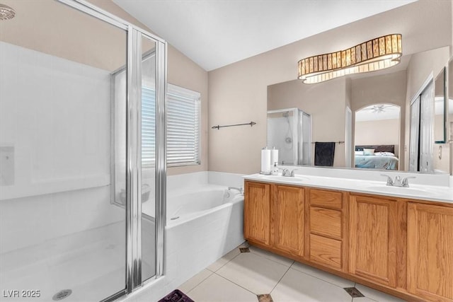 2104 Spanish Town Ave, North Las Vegas, NV 89031 - ensuite bathroom featuring a shower stall, a bath, double vanity, tile patterned floors, and vaulted ceiling