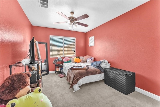 2104 Spanish Town Ave, North Las Vegas, NV 89031 - bedroom with carpet, a textured wall, baseboards, and a ceiling fan