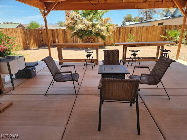 view of patio / terrace featuring a fenced backyard and an outdoor fire pit