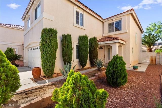 9522 Arrowhead Falls Ct, Las Vegas, NV 89148 - mediterranean / spanish house featuring a garage, a tiled roof, stucco siding, concrete driveway, and fence