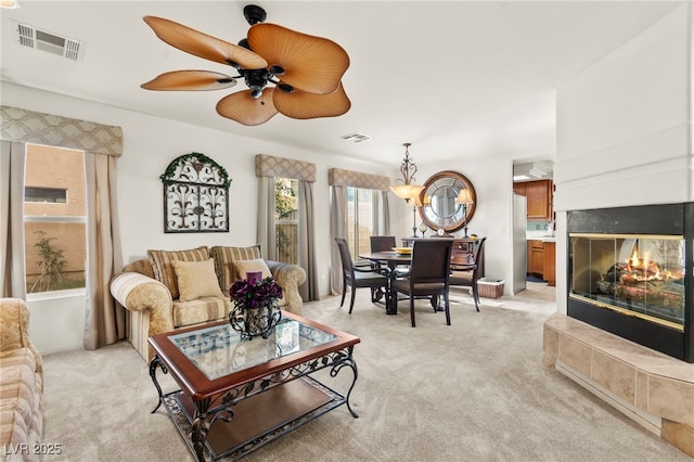 9522 Arrowhead Falls Ct, Las Vegas, NV 89148 - living area featuring light carpet, a ceiling fan, and a multi sided fireplace