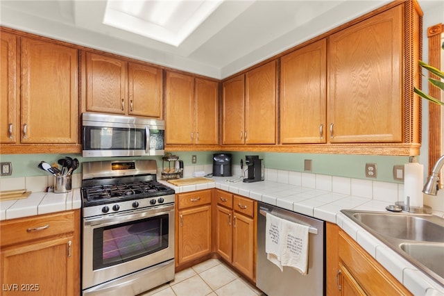 9522 Arrowhead Falls Ct, Las Vegas, NV 89148 - kitchen with appliances with stainless steel finishes, a sink, and brown cabinetry