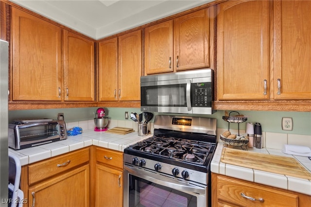 9522 Arrowhead Falls Ct, Las Vegas, NV 89148 - kitchen featuring appliances with stainless steel finishes and brown cabinetry