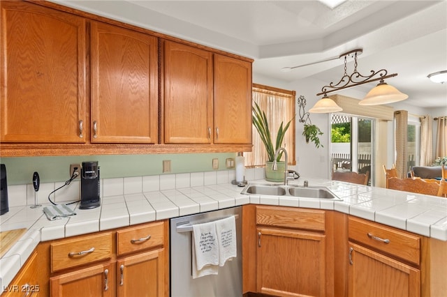 9522 Arrowhead Falls Ct, Las Vegas, NV 89148 - kitchen featuring dishwasher, a sink, a peninsula, light countertops, and pendant lighting